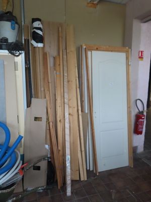 several pieces of wood are stacked up in a room next to a door