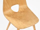 a wooden chair that has a hole in the back of it