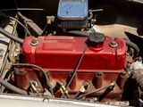 a red engine in the engine bay of a car