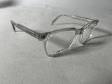 a pair of glasses sitting on a white surface