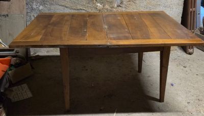 une table en bois placée au milieu d'une pièce