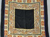 an image of a black and gold square scarf with a blue border