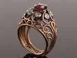 a close up of a gold ring with a ruby stone