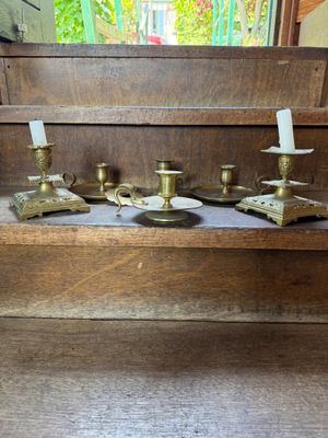 a wooden bench with a bunch of candles on top of it
