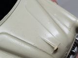 a close up of a white car with a red stripe on it