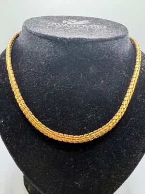 a close up of a necklace on a mannequin mannequin