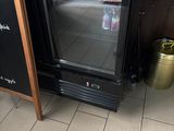 an image of a refrigerator in a restaurant with a chalk board
