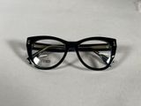 black cat eye glasses with clear lenses on a white surface