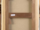 an image of a picture of a wooden frame with a label on it