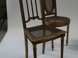 two chairs sitting next to each other on a white background