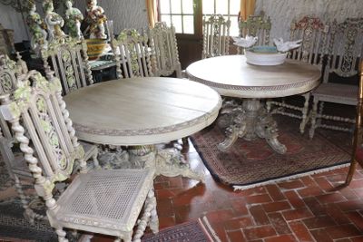 a table and chairs in a room with a rug on the floor