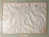 an old document with writing on it sitting on a table