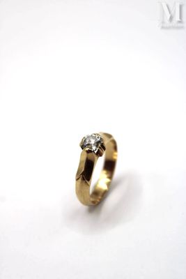 a close up of a gold ring with a diamond on it