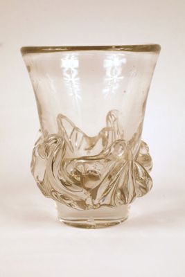 a glass vase with a design on it on a white surface