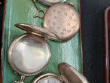 many different types of watches sitting on a tray