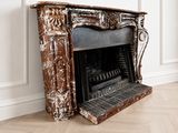a fireplace in the middle of a room with wood flooring