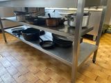 many pots and pans on a metal shelf in the kitchen