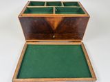 an old wooden box with a green tray on top of it
