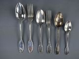 five spoons and a fork on a table