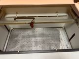 a metal box with a red handle on top of it