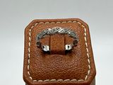 leather box with a ring on top of it on a white surface