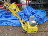 a small yellow machine that is sitting on the ground