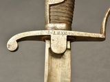 a close up of a sword with a metal handle