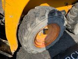 a yellow wheel on the back of a construction vehicle