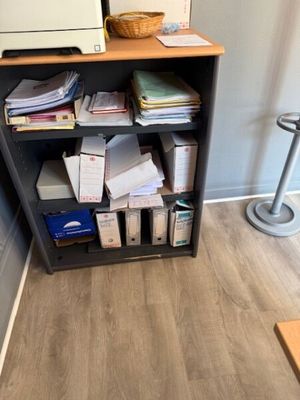 a book shelf with a bunch of papers on it