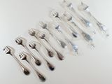 a lot of forks and spoons sitting on a table