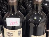 many bottles of wine sitting on a shelf in a store