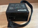 a computer power supply unit sitting on top of a wooden table