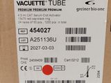 packaging of a wine bottle with a red dot on the label