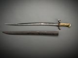 a close up of two swords on a gray surface