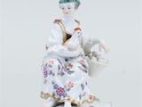 a porcelain figurine of a woman with a basket of flowers