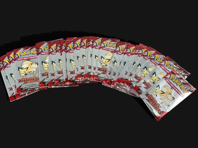 a close up of a bunch of pokemon trading cards on a black background