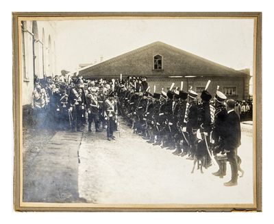 a group of men in uniform standing in front of a building