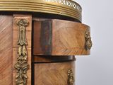 a wooden cabinet with a gold decoration on the top of it