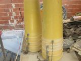 two yellow cylinders sitting on top of a table