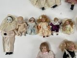 many dolls that are lined up together on a table