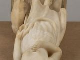 marble sculpture of a woman laying on her back on a table