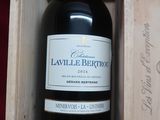 a bottle of wine in a wooden box on a table
