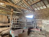 a barn with a lot of wood in it