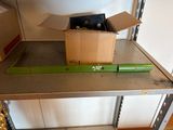 a box of beer on a metal shelf next to a box of beer