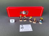 toy figurines of a group of people in front of a red box