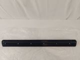 a close up of a black sound bar on a white surface