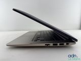 the back of a laptop computer sitting on top of a white table
