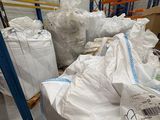 a large amount of bags of white bags in a warehouse