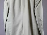 the back view of a military jacket hanging on a hanger