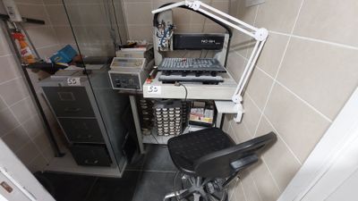 a desk with a computer and a chair in a room
